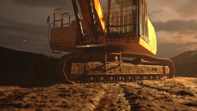 Excavator or digger at muddy construction site during sunset. Demolition, mining