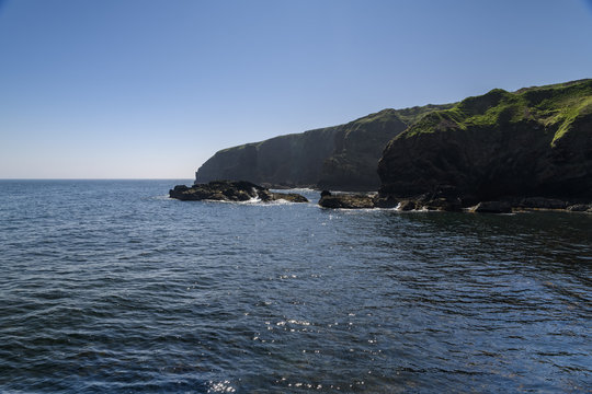 The southern cliffs at the entrance to Lybster Harbour in Caithness, Scotland.