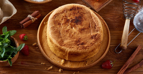Top view raw ingredients for cooking strawberry pie or cake on wooden table, flat lay. Bakery background.