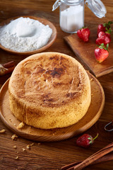 Delicious cake with fresh organic strawberries and kitchen utensils, top view, close-up, selctive focus.