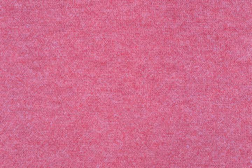 Fabric knitting wool texture pink color. Cloth knitted wool background.