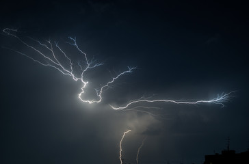 Fototapeta na wymiar thunderstorm and lightning on a summer night over a sleeping city
