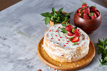 Tart with strawberries and whipped cream decorated with mint leaves on white textured background, selective focus