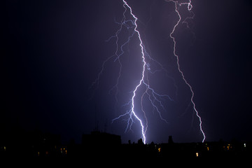 thunderstorm and lightning on a summer night over a sleeping city