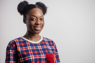 cheerful Afro girl with beautiful hairstyle looking at the camera. copyspace. black animator...