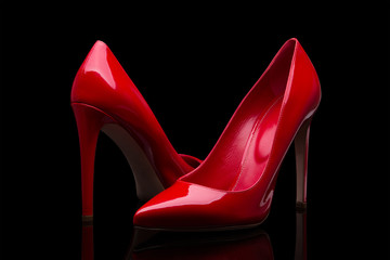 Elegant red shoes on a black background - obrazy, fototapety, plakaty