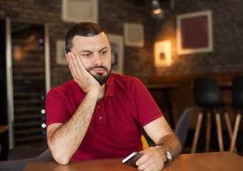 Bored man holding phone