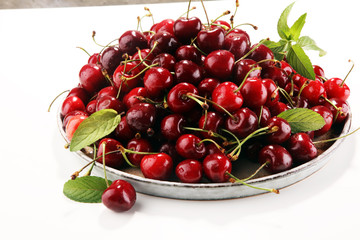 Cherry. Red fresh Cherries in bowl and a bunch of cherries on the table