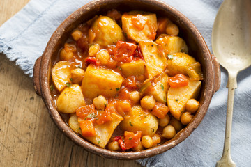 Patatas bravas. Roasted potatoes with chickpeas in tomato sauce. 