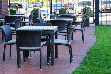 Empty coffee terrace with rattan outdoor tables and chairs