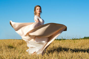 gorgeous girl in beautiful dress in field