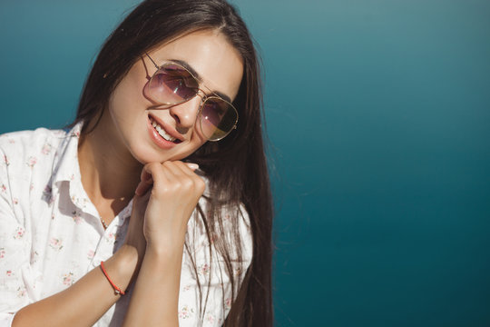 Close up portrait of young attractive woman wearing sunglasses