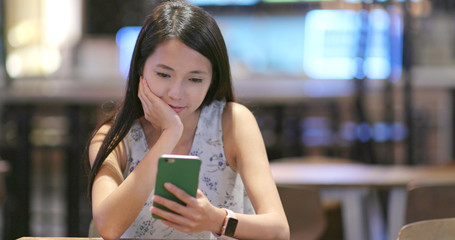 Woman read on mobile phone in coffee shop
