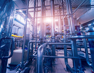 Modern interior of a brewery. Barrels and pipes. Factory interior.