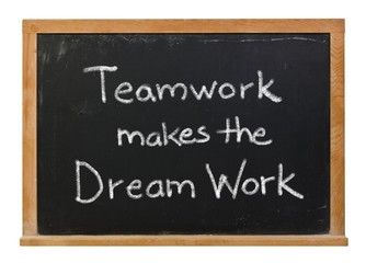 Teamwork makes the dream work written in white chalk on a black chalkboard isolated on white