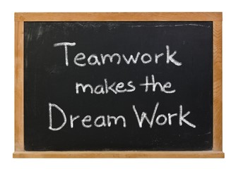 Obraz premium Teamwork makes the dream work written in white chalk on a black chalkboard isolated on white