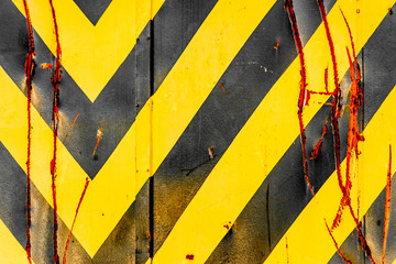 Close-Up Of A Rusty Black And Yellow Warning Sign