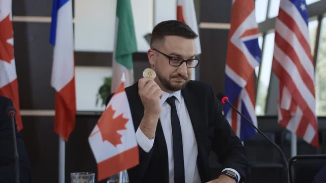 Formal representation of Canada standing on tribune and delivering speech about cryptocurrency of bitcoin on international summit