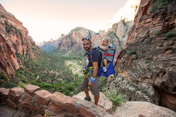 Obraz premium A man with his baby boy are trekking in Zion national park, Utah, USA