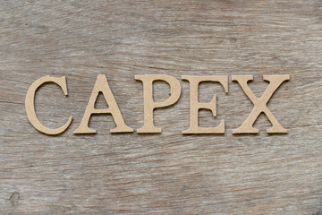Alphabet letter in word CAPEX (Abbreviation of Capital Expenditure) on wood background
