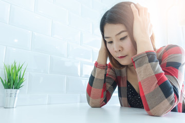 Businesswoman at desk in office. Businesswoman being depressed by working in office.Strain,Yong business woman to think and not Work with stress.