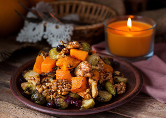 Festive salad with brussels sprout, pumpkin, nuts, cranberries
