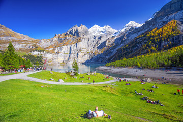 Amazing tourquise Oeschinnensee with waterfalls, wooden chalet and Swiss Alps, Berner Oberland,...