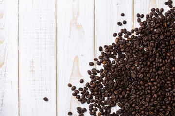 Coffee beans on white wooden table