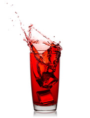 Splash of cherry juice from ice cubes in transparent glass