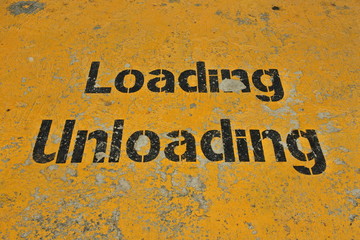 Old warehouse floor with words loading - unloading 
