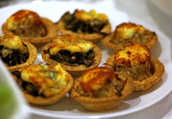 tartlets with cheese and mushrooms on a festive table.