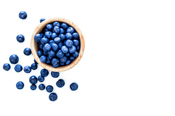 Fresh recently picked blueberries in bowl on white background top view copy space
