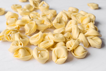 uncooked ravioli on marble