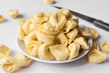 uncooked ravioli on marble