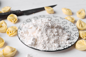 ravioli and flour dish on marble