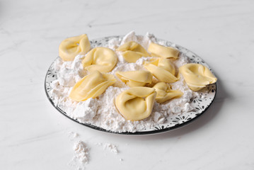 ravioli and flour dish on marble
