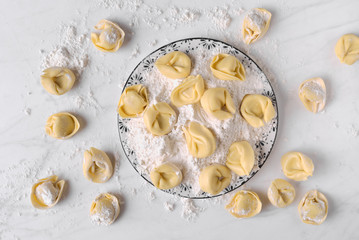 ravioli and flour dish on marble