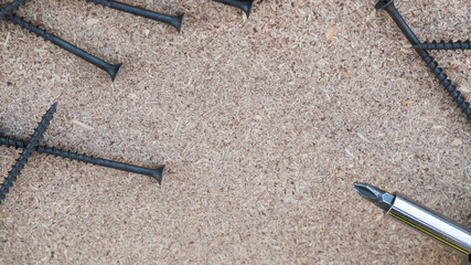 screws and electrical screwdirer on the flake boards. Concept of the DIY tools sale, apartments redecorating, reconstruction, renovation, DIY shops, home improvement.