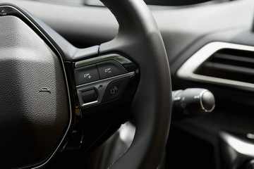 Detail of the steering wheel buttons of a car.
