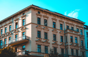 Fototapeta na wymiar orange residential building with blue sky in the background