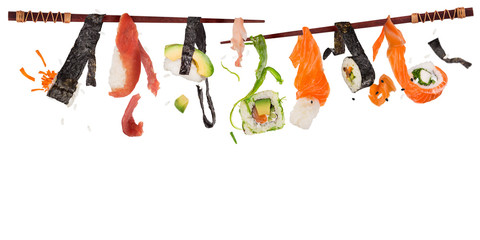 Pieces of delicious japanese sushi frozen in the air.