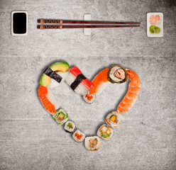Traditional japanese sushi pieces making inscription and heart symbol.