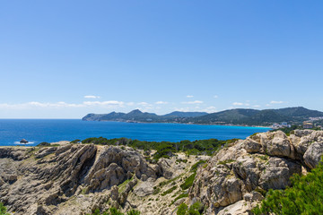 Fototapeta na wymiar Mallorca, Houses and coast of Cala Ratjada from rocky hills of capdepera