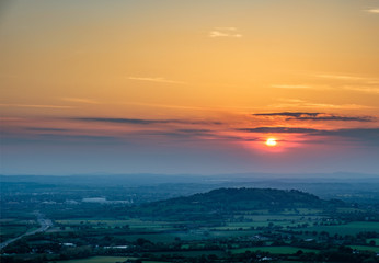 Fototapeta na wymiar Sunset viewed from Crickley Hill looking towards Gloucester and the hills in the distance.