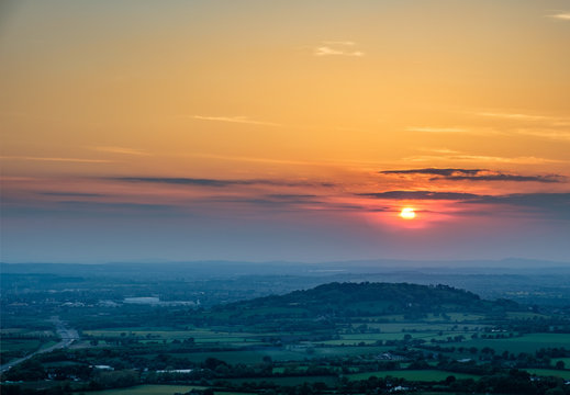 Sunset viewed from Crickley Hill looking towards Gloucester and the hills in the distance.