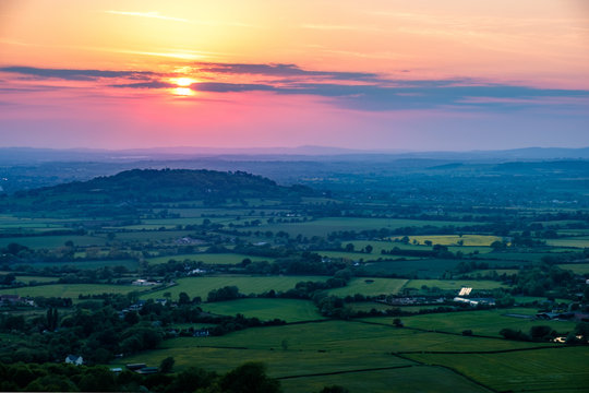 Sunset viewed from Crickley Hill looking towards Gloucester and the hills in the distance.