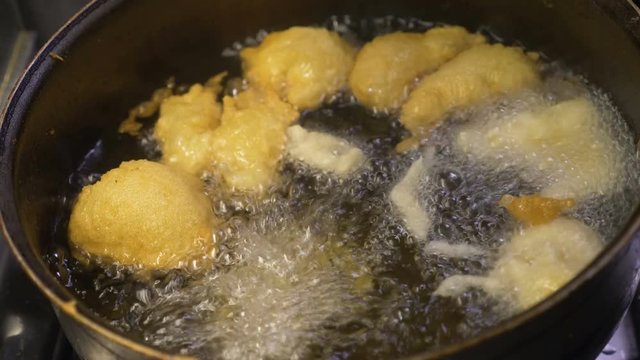 South of Italy: cooking zeppole in frying olive oil. Typical Italian specialty