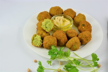 Falafel on a white plate on a white background