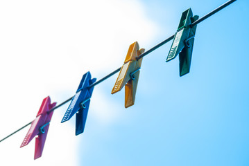 Colorful plastic clothespins on a rope