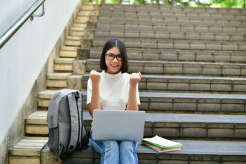 Business Concepts. Beautiful girl playing computer in the building. Beautiful businesswoman succeeds in working.